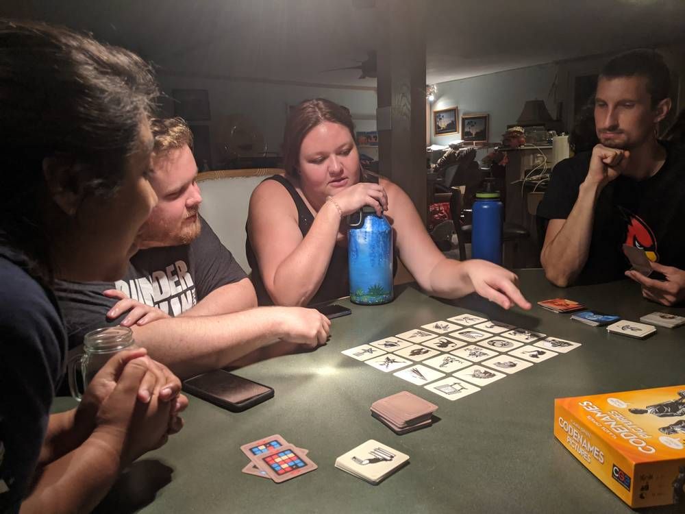 Adults around a table learning a card game